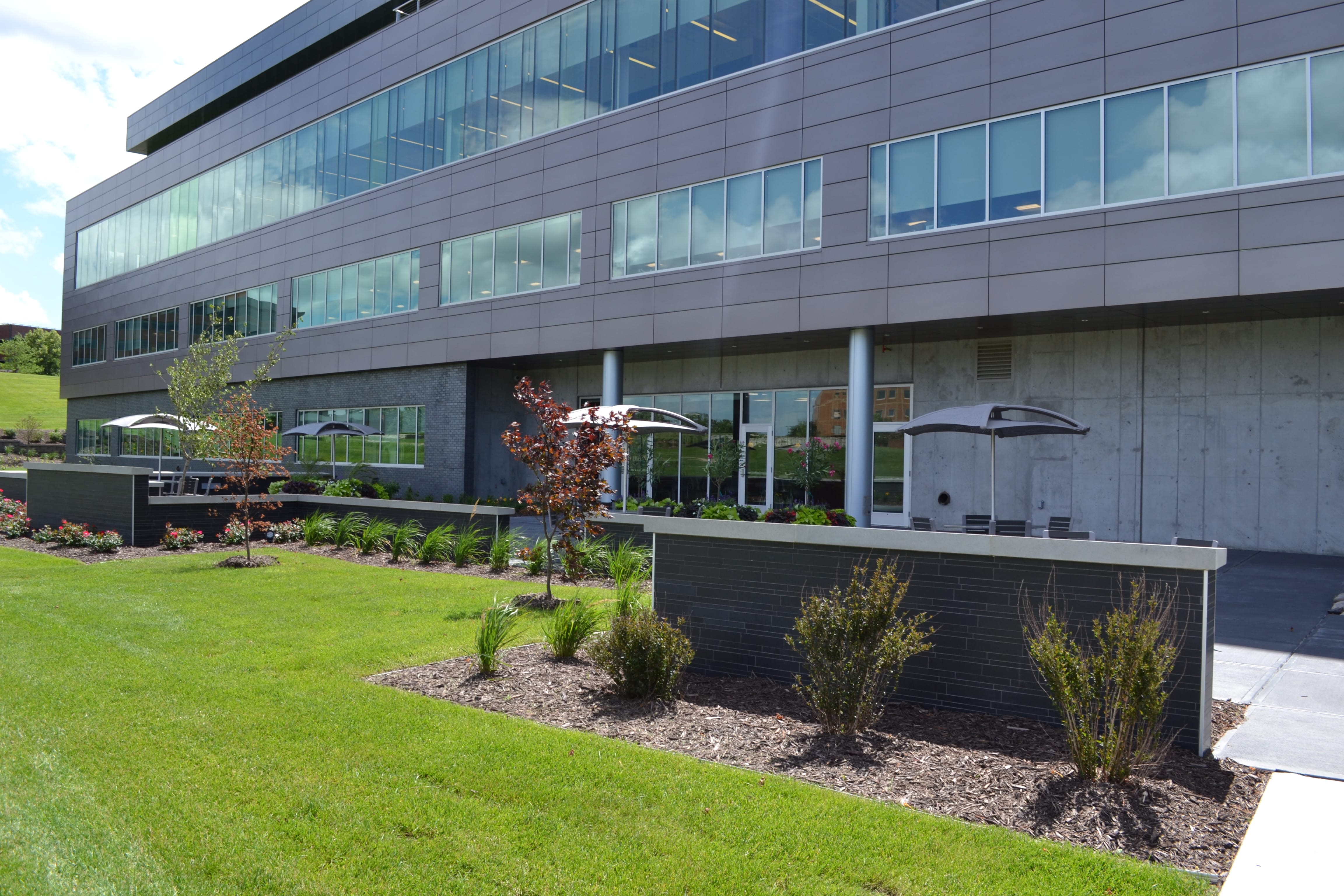 Norstone's Ebony Lynia Natural Stone Interlocking Wall Tiles used on an exterior landscaping wall at an office building in Nebraska